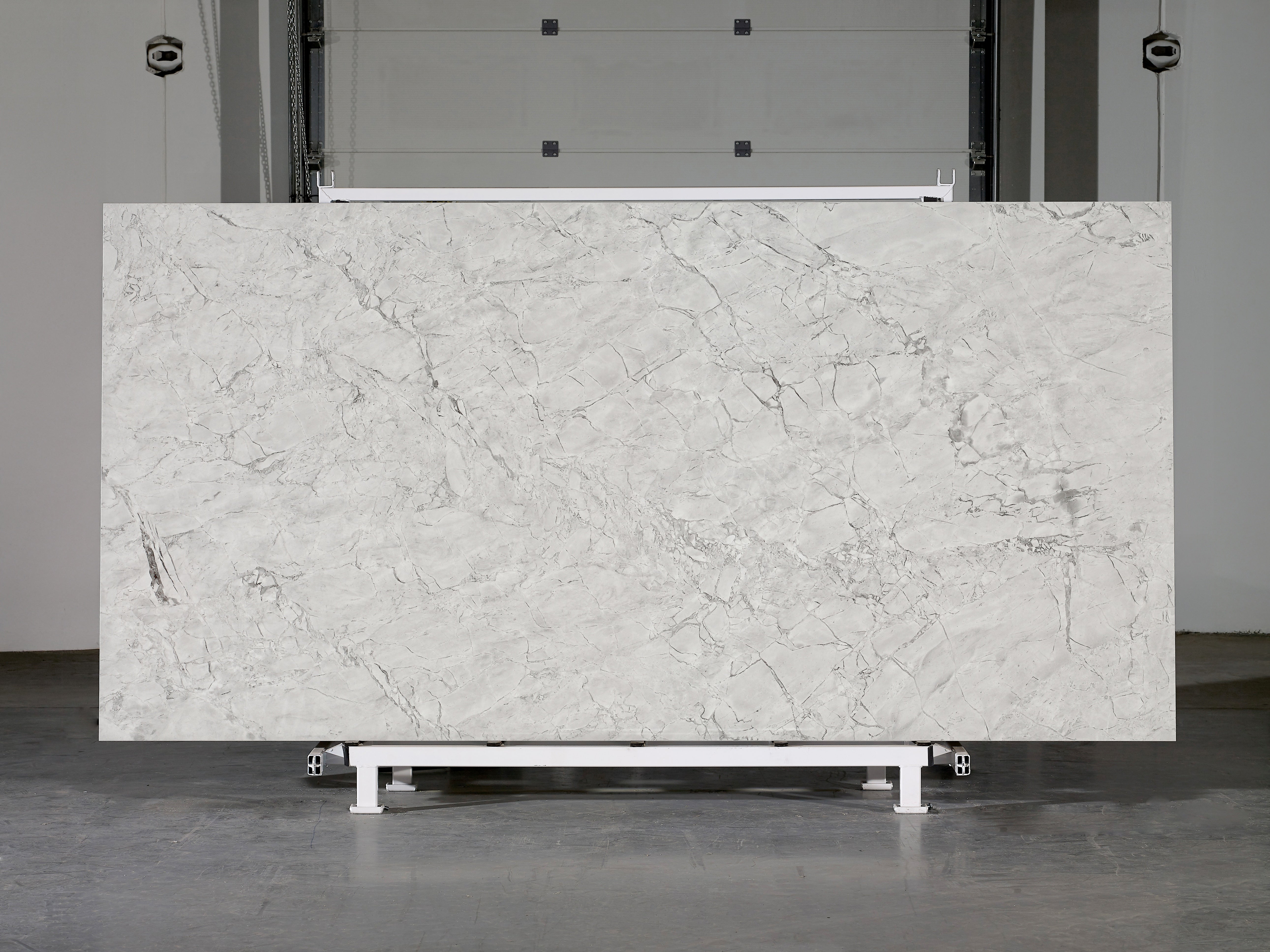 Majesto Super White sintered stone slabs by Anatolia, top-down product view, 64"×127"×15/32" size. Turkish sintered stone for floors and walls.