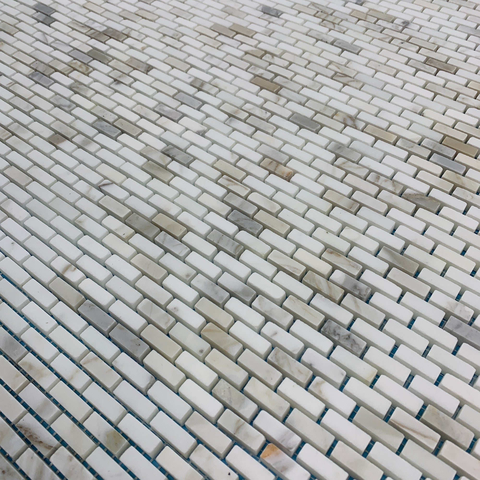 Elon Tile Calacatta Gold Mosaic tile arrangement — available at Surface Group