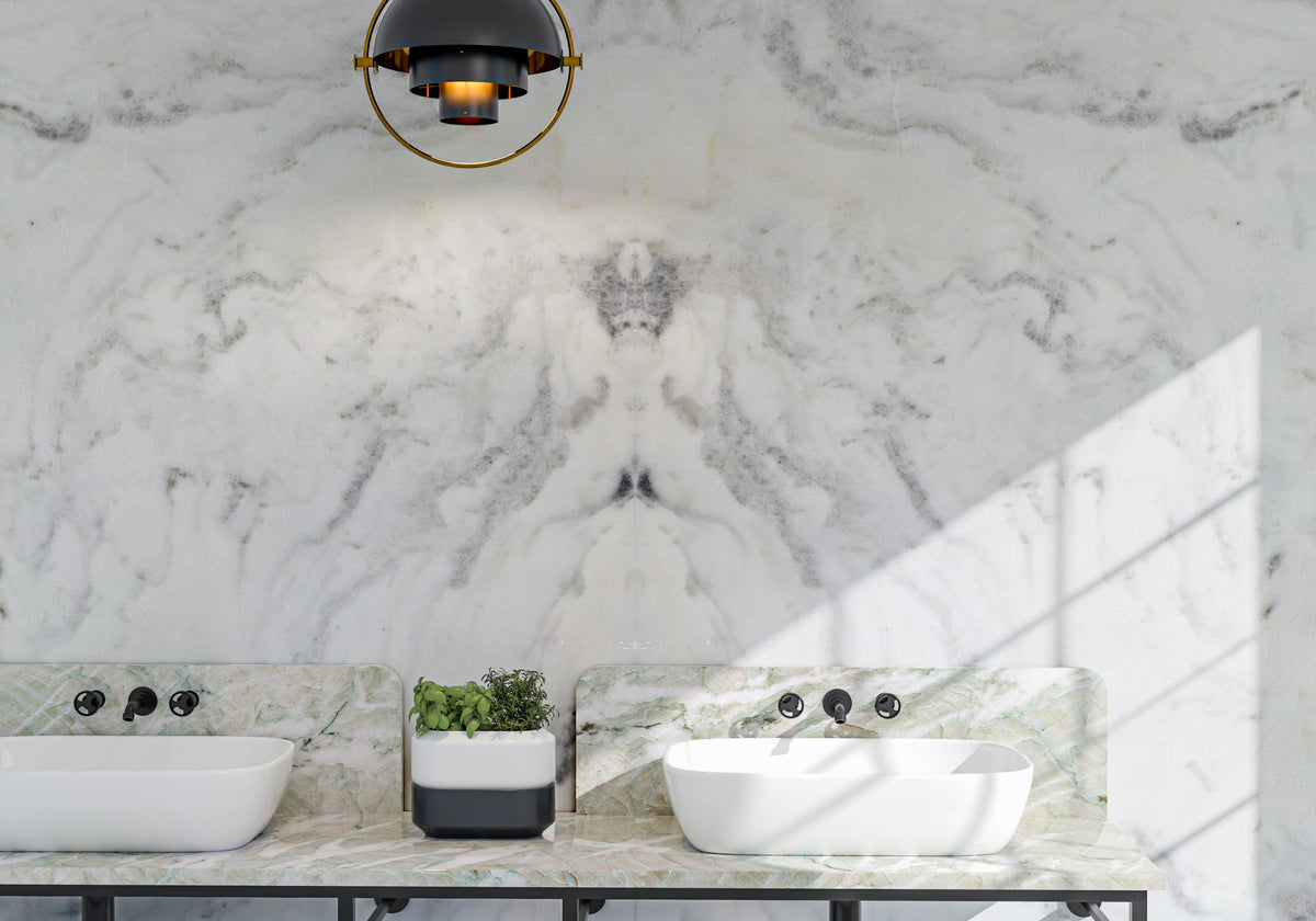 Marble Systems Marble Slabs Calacatta Covelano glossy marble tile in a room setting — available at Surface Group